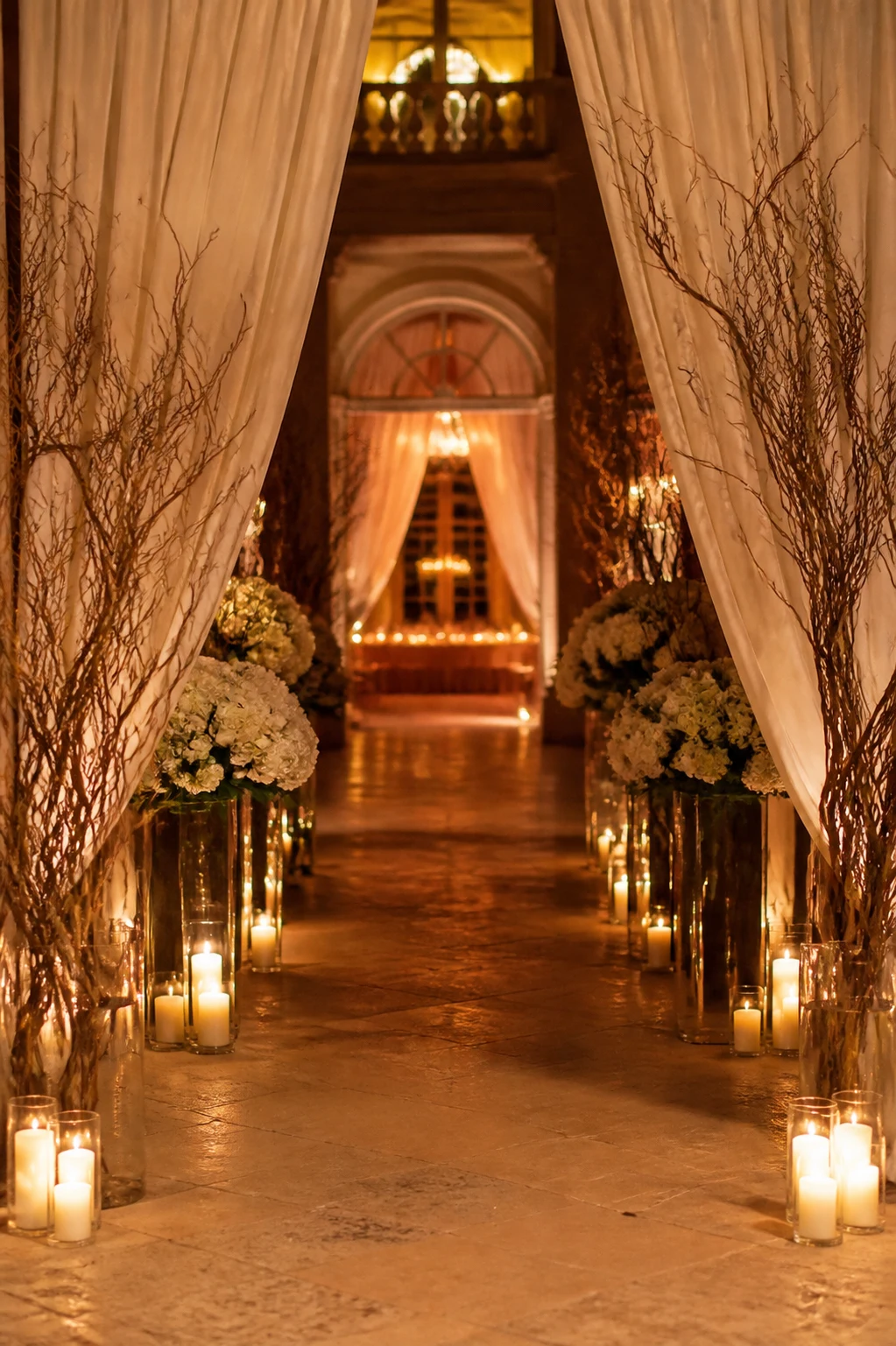 Elegant candlelit event entrance framed by ivory draping and florals